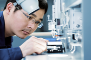 manufacturing worker looking at object in detail