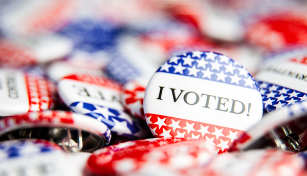 Pile of circular pins in red, white and blue that say "I Voted!"