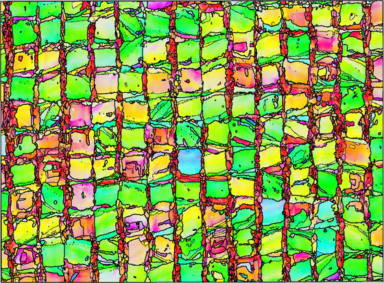 Brightly colorized micrograph of crystallographic orientations in AM test artifact shows ragged grid of squares.