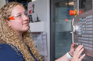 student working on a manufacturing machine