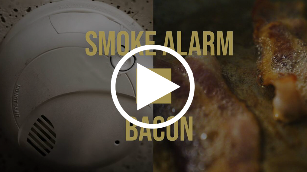 Video title screen reads "Smoke Alarms vs. Bacon" with pictures of each. 