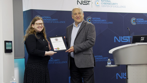 County Executive Marc Elrich presenting NCCoE Director Cherilyn Pascoe with a Certificate of Recognition and Appreciation