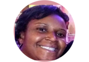 Close up of Mary Butler, a woman with short black hair, smiling.