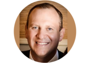 Headshot of Brent Holden, a man with short brown hair, smiling.