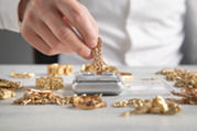 gold being weighed on a scale