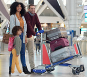 family with luggage at the airport
