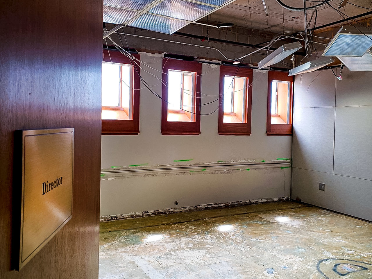 Photo of asbestos abatement of Director's Office on the mezzanine of NLM Building 38. Sunlight is shining through windows.