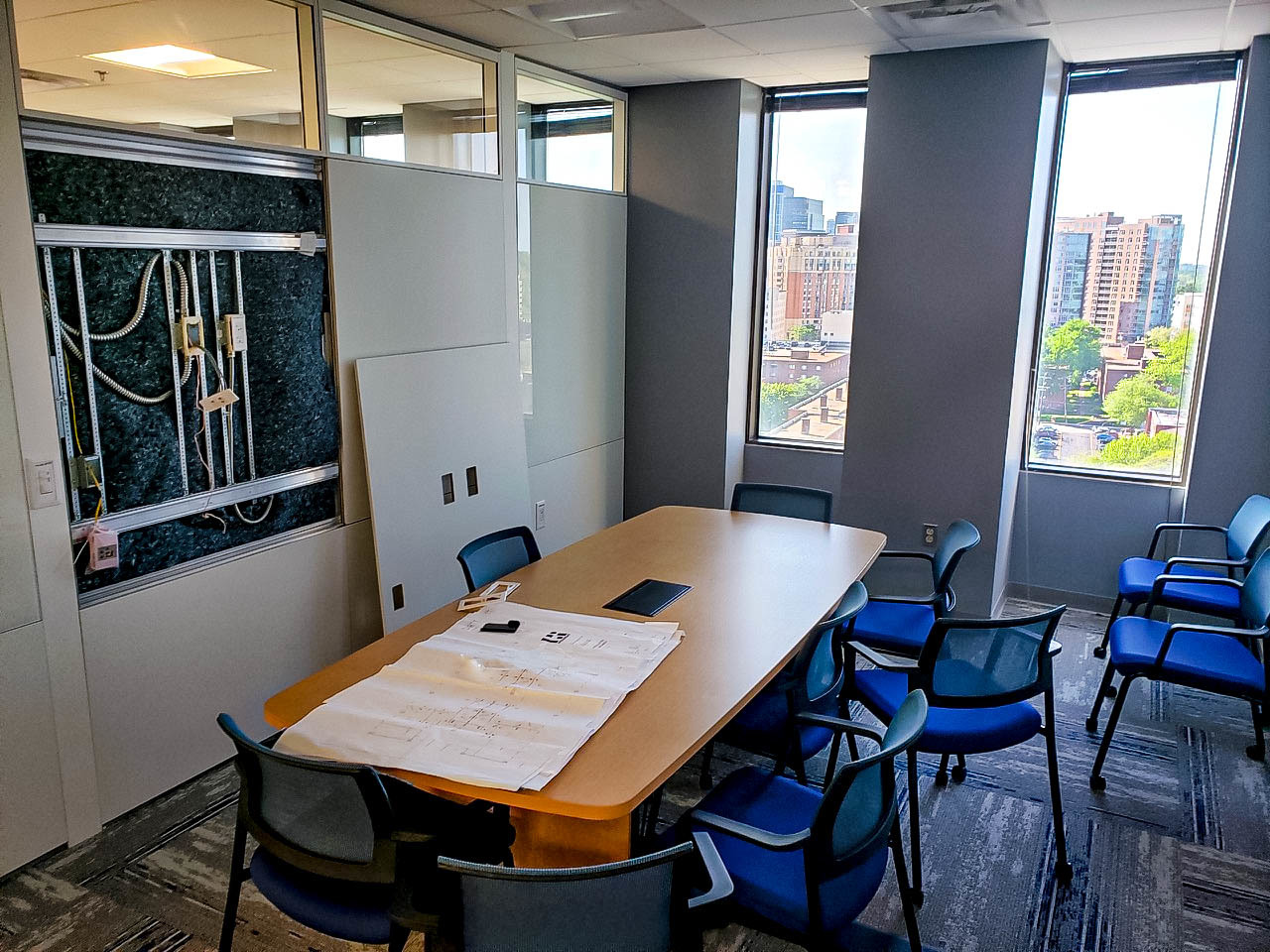 Photo of Building 38A 9th floor renovation finishing touches. Small conference room is shown.