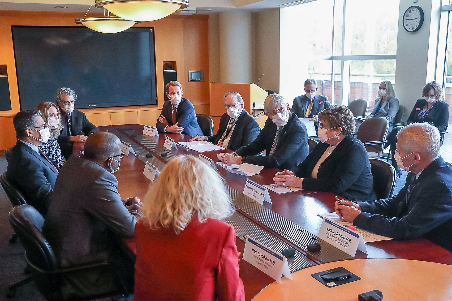 Dr. Patti Brennan, Dr. Frances Collins, and other NIH ICs talking to HHS Secretary Xavier Becerra.