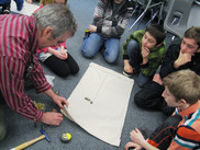 Jim Manning shows students how to make a sail for a surface drifter during a classroom workshop. NOAA Fisheries