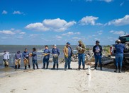 Conservation corps members build an oyster reef.