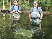 Former NOAA veteran intern Barney Boyer (left) out in the field with a colleague deploying water quality testing equipment. 