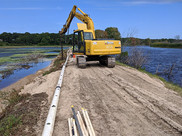 Construction equipment in use in a wetland
