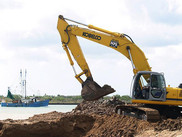 Construction equipment removing debris from a river.