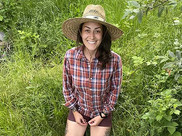  Tillie Smith kneeling among dense green vegetation