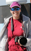 Laura Dias on a research ship holding her camera