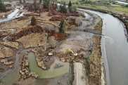Aerial photo of two excavators in a wetland with a stream nearby