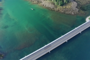 Aerial view of a river with a road spanning across it.