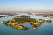 Aerial view of a large forested island in the middle of a river. Credit: Friends of the Detroit River