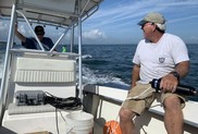 Two men on a boat in the Chesapeake Bay. One is piloting, the other holding a telemetry device.