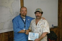 Ken Keene (L) and Jimmy Rollo celebrating Rollo’s 100th trip as an observer. Credit: NOAA Fisheries.