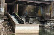 A fish passage structure and dam underneath a bridge.