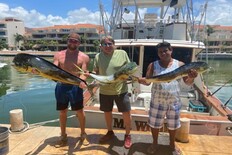 Friends showing their catches of dolphinfish.