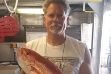 Kevin holding a large red snapper.