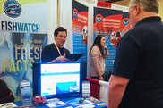NOAA staff talking with visitors at exhibits booth