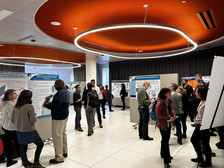 large meeting space with information stations and posters