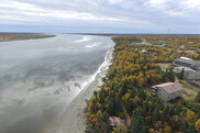 Aerial view of a village on the bank of a river surrounded by forests