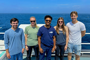 Group shot of scientists on the deck of a ship