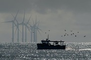 wind turbines and a small ship