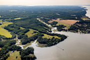 An aerial view of a Middle Peninsula shoreline that includes creeks, wetlands, and forested and agricultural areas. (Credit: Will Parson, CBP).