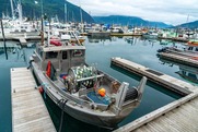 Commercial fishing vessel at marina near mountains