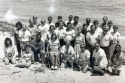 black and white group photo on a beach