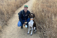 A young man and a dog on a trail