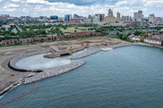 Aerial view of construction equipment along a shoreline park.