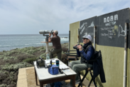 Marine mammal observers, LTJG Jesse Pierce (left) and Dawn Breese (right), surveying for mother-calf gray whale pairs.