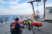 Woods Hole Oceanographic Institution engineer Owen Ceserano downloads images collected from a long-range autonomous underwater vehicle