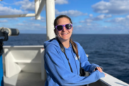 Teacher at Sea Kiersten Newtoff smiles at the camera aboard NOAA Ship Pisces.