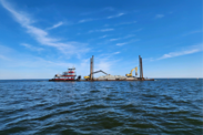 Stevens Towing excavators on a barge building new oyster sanctuary reefs in the Pamlico Sound, North Carolina. 