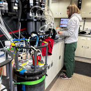Running water samples from the ship’s flow-through system through a fluorometer to measure phytoplankton optical properties
