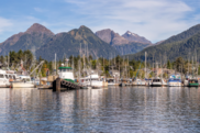 Commercial fishing boats with mountains in the background- Shutterstock image