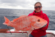 Woman holding red snapper