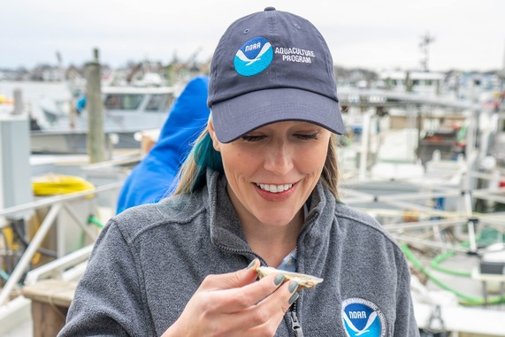 Danielle Blacklock from NOAA Fisheries holds an oyster. 