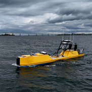 Yellow uncrewed surface vehicle at sea