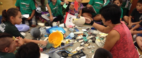 Students in a circle, learning about marine debris.