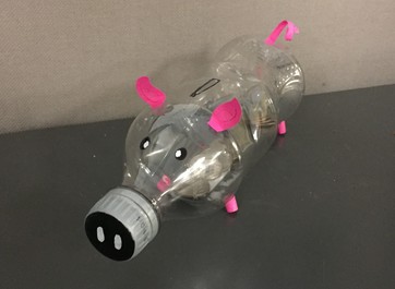 A piggy bank made from a plastic bottle.