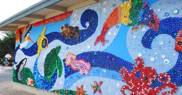 An ocean scene mural made from plastic bottle caps.